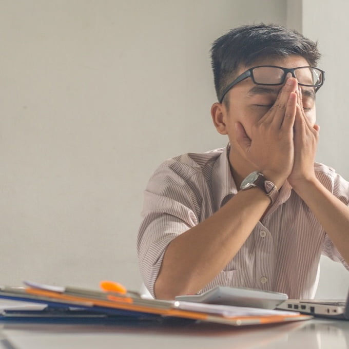 Guy feeling tired at work